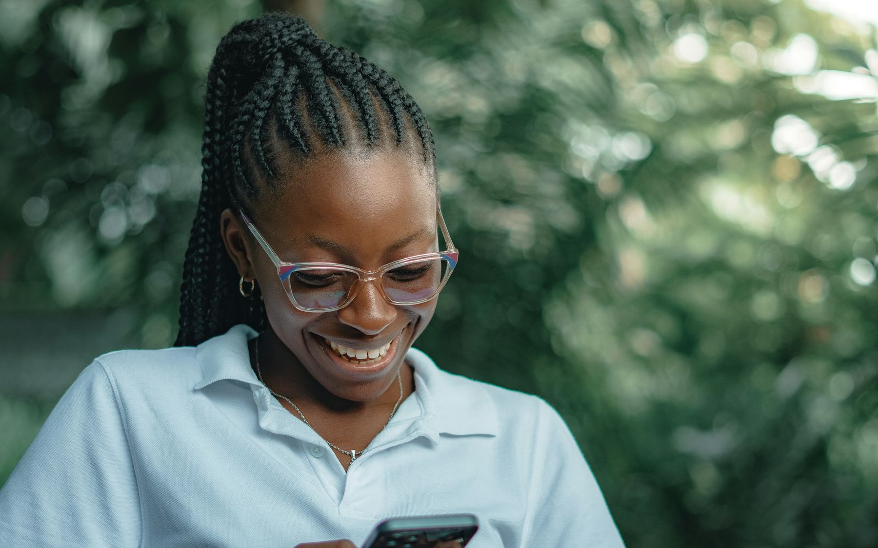 A smiling woman reading search results on her phone