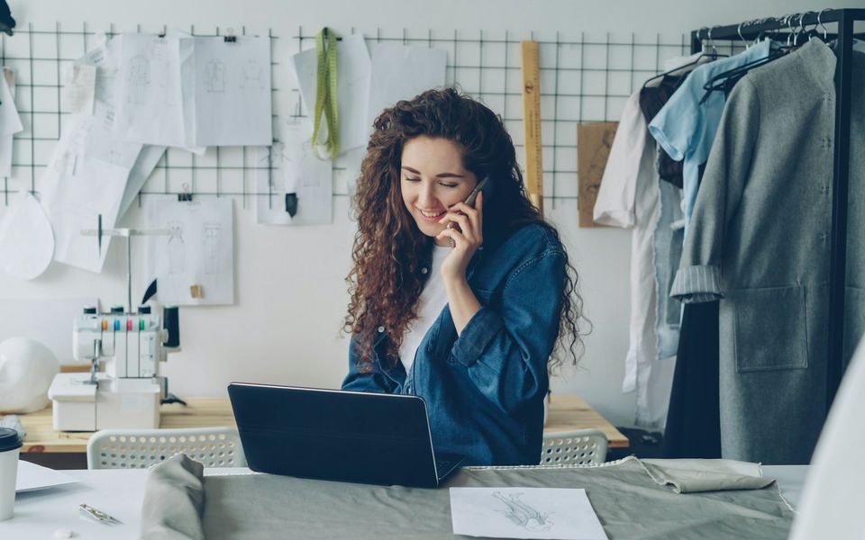 A small business owner on the phone in her design studio
